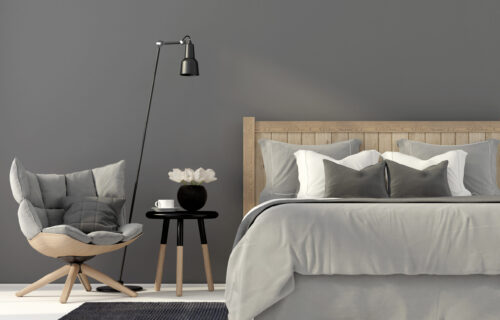 Gray bedroom with a wooden bed